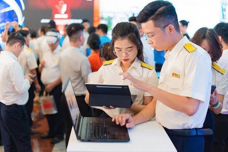 Người dân trao đổi với cán bộ và sử dụng thiết bị số tại quầy hỗ trợ
